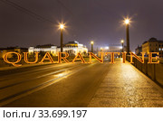 Coronavirus in Prague, Czech Republic. Night view of Prague. Quarantine sign on a blurred background. Concept of COVID pandemic and travel in Europe. (2019 год). Стоковое фото, фотограф Владимир Журавлев / Фотобанк Лори