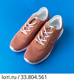 Moscow, Russia - May 15. 2020 Brown textile Ascot sneakers on a blue background. Редакционное фото, фотограф Володина Ольга / Фотобанк Лори