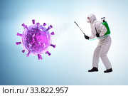 Disinfection concept with person fighting coronavirus. Стоковое фото, фотограф Elnur / Фотобанк Лори