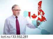 Concept of immigration to Canada with virtual button pressing. Стоковое фото, фотограф Elnur / Фотобанк Лори