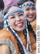 Portrait of smiling expression female in national clothing indigenous inhabitants of Kamchatka. Celebration Koryak traditional holiday Hololo Day of Seal (2018 год). Редакционное фото, фотограф А. А. Пирагис / Фотобанк Лори