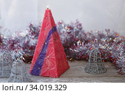 Decorative Handmade candle in the shape of a pyramid. Стоковое фото, фотограф Nataliia Zhekova / Фотобанк Лори