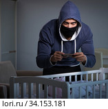 Criminal stealing baby in human child traficking concept. Стоковое фото, фотограф Elnur / Фотобанк Лори