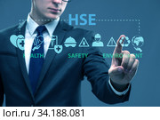 HSE concept with businessman pressing virtual button. Стоковое фото, фотограф Elnur / Фотобанк Лори