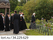 Russia, Veliky Novgorod, Yuriev monastery-July 14, 2020: Archimandrite ili (Nozdrin), Metropolitan Lev of Novgorod and old Russia, Bishop Arseniy of Yuriev together with the monastery's brethren approach the Spassky Cathedral. Редакционное фото, фотограф Филатова Ирина / Фотобанк Лори