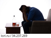 Young man suffering from alcoholism. Стоковое фото, фотограф Elnur / Фотобанк Лори