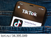 TikTok ("ТикТок"). Мобильный телефон в кармане джинсов (2020 год). Редакционное фото, фотограф E. O. / Фотобанк Лори