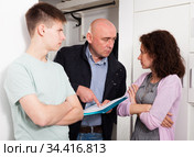 Debt collector and worried woman and teenage son. Стоковое фото, фотограф Яков Филимонов / Фотобанк Лори
