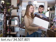 Woman looking for stylish knickknacks for apartment in shop. Стоковое фото, фотограф Яков Филимонов / Фотобанк Лори