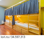 The hostel dormitory beds arranged in room. Стоковое фото, фотограф Elnur / Фотобанк Лори