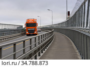 Truck on Tromso Bridge crosses Tromsoysundet strait between Tromsdalen on mainland and island of Tromsoya (2016 год). Редакционное фото, фотограф Валерия Попова / Фотобанк Лори