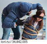 Criminal taking businesswoman as hostage in office. Стоковое фото, фотограф Elnur / Фотобанк Лори