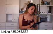 Young latina female assistant standing with clipboard politely welcoming to modern office. Стоковое видео, видеограф Яков Филимонов / Фотобанк Лори