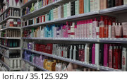 Various of haircare cosmetics and wigs for sale on shelves of specialty cosmetic shop (2020 год). Редакционное видео, видеограф Яков Филимонов / Фотобанк Лори