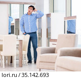Young man shopping in furniture store. Стоковое фото, фотограф Elnur / Фотобанк Лори