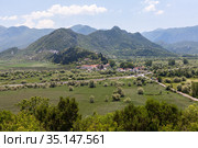 Little fishermans village on the road from Podgorica towards the coast. It is on the Crmnica river, near the Skadar lake in the municipality of Bar. Virpazar, Montenegro (2016 год). Редакционное фото, фотограф Кекяляйнен Андрей / Фотобанк Лори