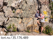 a mature sports couple on the top of Aleksandrovskaya Sopka mountain near the town of Zlatoust in the Chelyabinsk region in Russia. Стоковое фото, фотограф Акиньшин Владимир / Фотобанк Лори