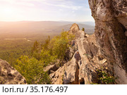 man and woman tourists on the rocky peak Aleksandrovskaya Sopka against the background of the city of Zlatoust on a summer sunny day. Стоковое фото, фотограф Акиньшин Владимир / Фотобанк Лори