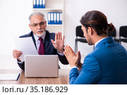 Young male candidate employee meeting with old recruiter. Стоковое фото, фотограф Elnur / Фотобанк Лори