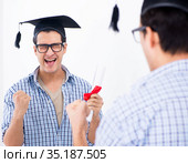 Young student planning graduation speech in front of mirror. Стоковое фото, фотограф Elnur / Фотобанк Лори