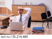 Young male employee unhappy with office prank in the office. Стоковое фото, фотограф Elnur / Фотобанк Лори