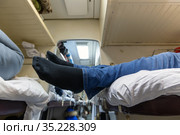 Male legs in black socks in the aisle of a train car. Стоковое фото, фотограф Володина Ольга / Фотобанк Лори