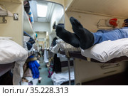 Male legs in black socks in the aisle of a train car. Стоковое фото, фотограф Володина Ольга / Фотобанк Лори