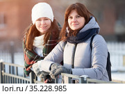 Happy young couple women in winter season, two girlfriends portrait in sunlight on urban street. Стоковое фото, фотограф Кекяляйнен Андрей / Фотобанк Лори