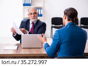 Young male candidate employee meeting with old recruiter. Стоковое фото, фотограф Elnur / Фотобанк Лори