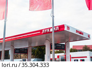 Saratov, Russia - 11/01/2020: Lukoil fuel station, the car is refueled with gasoline, petrol. Редакционное фото, фотограф Светлана Евграфова / Фотобанк Лори