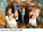 Tween children solving riddles in quest room., toned image. Стоковое фото, фотограф Яков Филимонов / Фотобанк Лори