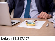 Old male employee auditor holding loupe at workplace. Стоковое фото, фотограф Elnur / Фотобанк Лори