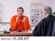Old male judge meeting with young captive in courthouse. Стоковое фото, фотограф Elnur / Фотобанк Лори