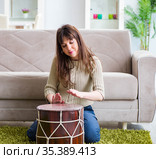 Woman playing drums at home. Стоковое фото, фотограф Elnur / Фотобанк Лори