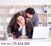 Sexual harassment concept with man and woman in office. Стоковое фото, фотограф Elnur / Фотобанк Лори