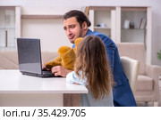 Girl bothering young father during working from house in pandemi. Стоковое фото, фотограф Elnur / Фотобанк Лори