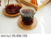 Very bubbly aerated coffee in a glass. Manual brewing, third wave specialty concept. Стоковое фото, фотограф Кристина Сорокина / Фотобанк Лори