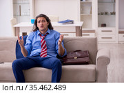 Young male employee being fired from his work at home. Стоковое фото, фотограф Elnur / Фотобанк Лори