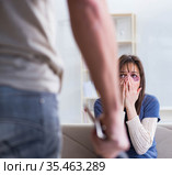 Desparate wife with aggressive husband in domestic violence conc. Стоковое фото, фотограф Elnur / Фотобанк Лори