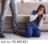 Desparate wife with aggressive husband in domestic violence conc. Стоковое фото, фотограф Elnur / Фотобанк Лори