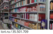 Various of haircare cosmetics and wigs for sale on shelves of specialty cosmetic shop (2020 год). Редакционное видео, видеограф Яков Филимонов / Фотобанк Лори