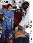 Rescue team making defibrillation to patient. Стоковое фото, фотограф Яков Филимонов / Фотобанк Лори