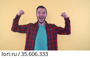 Ecstatic man in triumphing victory or win with clenched fists. Success. Стоковое видео, видеограф Mihail Mihaylov / Фотобанк Лори