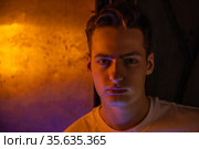 Portrait of attractive young man in neon lighting. Стоковое фото, фотограф Женя Канашкин / Фотобанк Лори