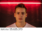 Portrait of attractive young man in neon lighting. Стоковое фото, фотограф Женя Канашкин / Фотобанк Лори