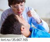 Woman dentist doctor with male patient in hospital. Стоковое фото, фотограф Elnur / Фотобанк Лори