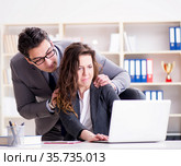 Sexual harassment concept with man and woman in office. Стоковое фото, фотограф Elnur / Фотобанк Лори