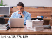 Young male employee unhappy with excessive work. Стоковое фото, фотограф Elnur / Фотобанк Лори