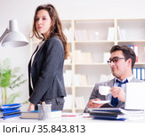 Sexual harassment concept with man and woman in office. Стоковое фото, фотограф Elnur / Фотобанк Лори