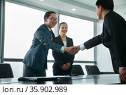 Businessmen Greeting Each Other with a Handshake. Стоковое фото, агентство Ingram Publishing / Фотобанк Лори